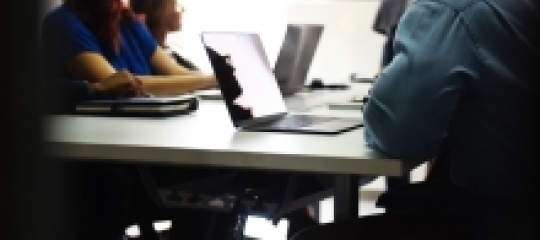 aesthetic picture of people on a desk with computers